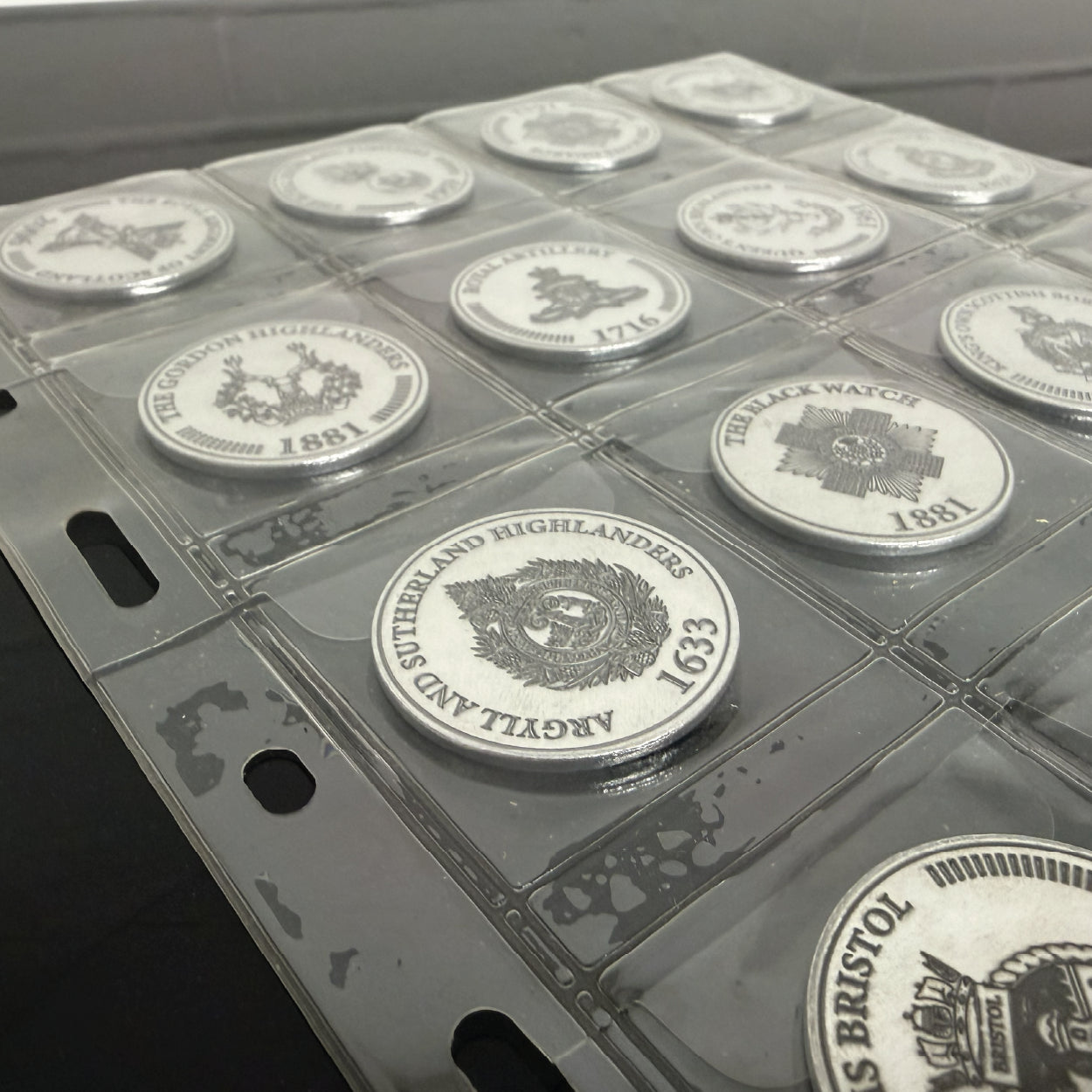 Regimental emblems engraved on aluminium coins at Cobblestone Creative workshop.
