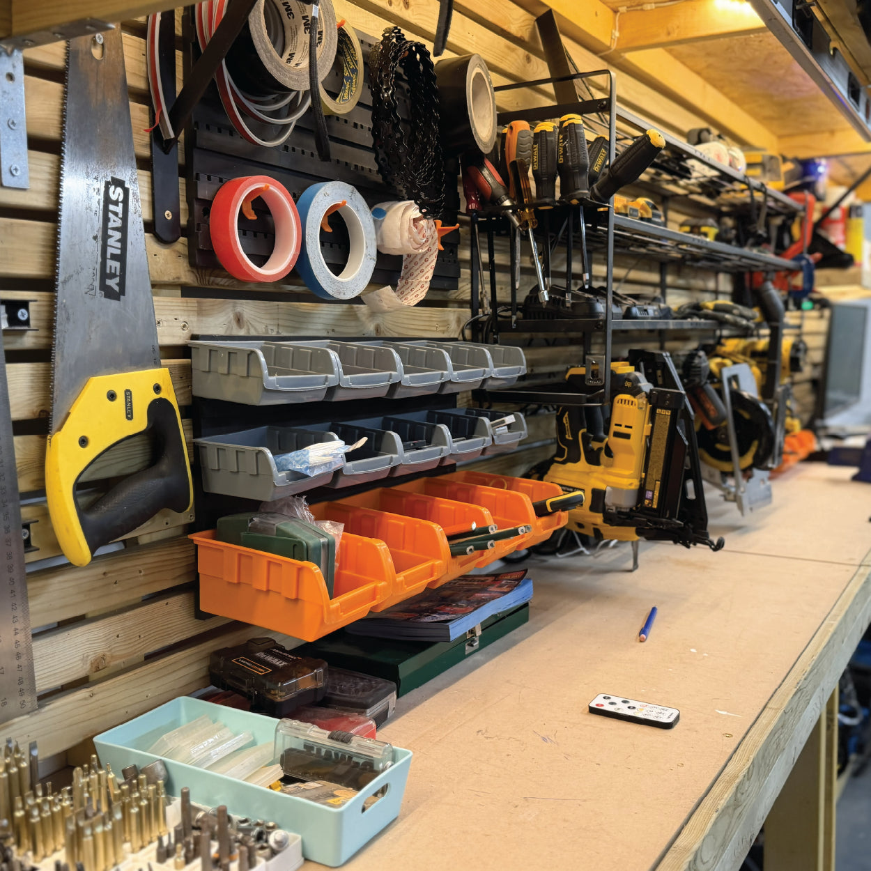 A wall with hand tools and power tools at the Cobblestone Creative workshop.