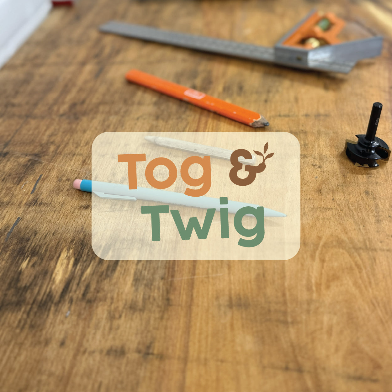 Tog & Twig logo overlaid on an elm slab with a selection of tools.